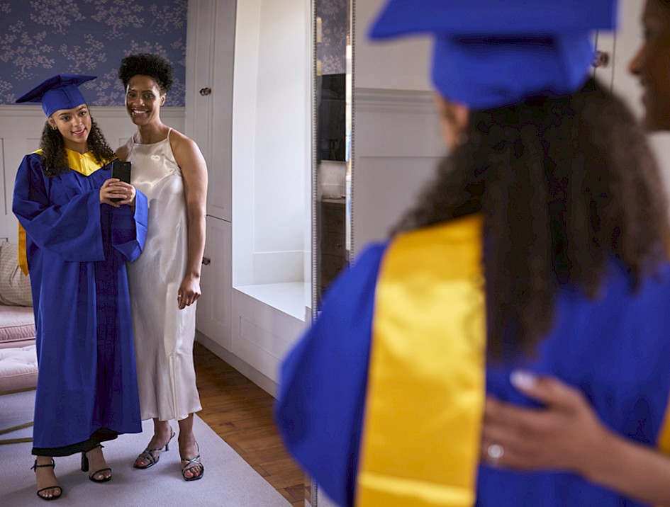 Photo of school graduate posing for picture with mother
